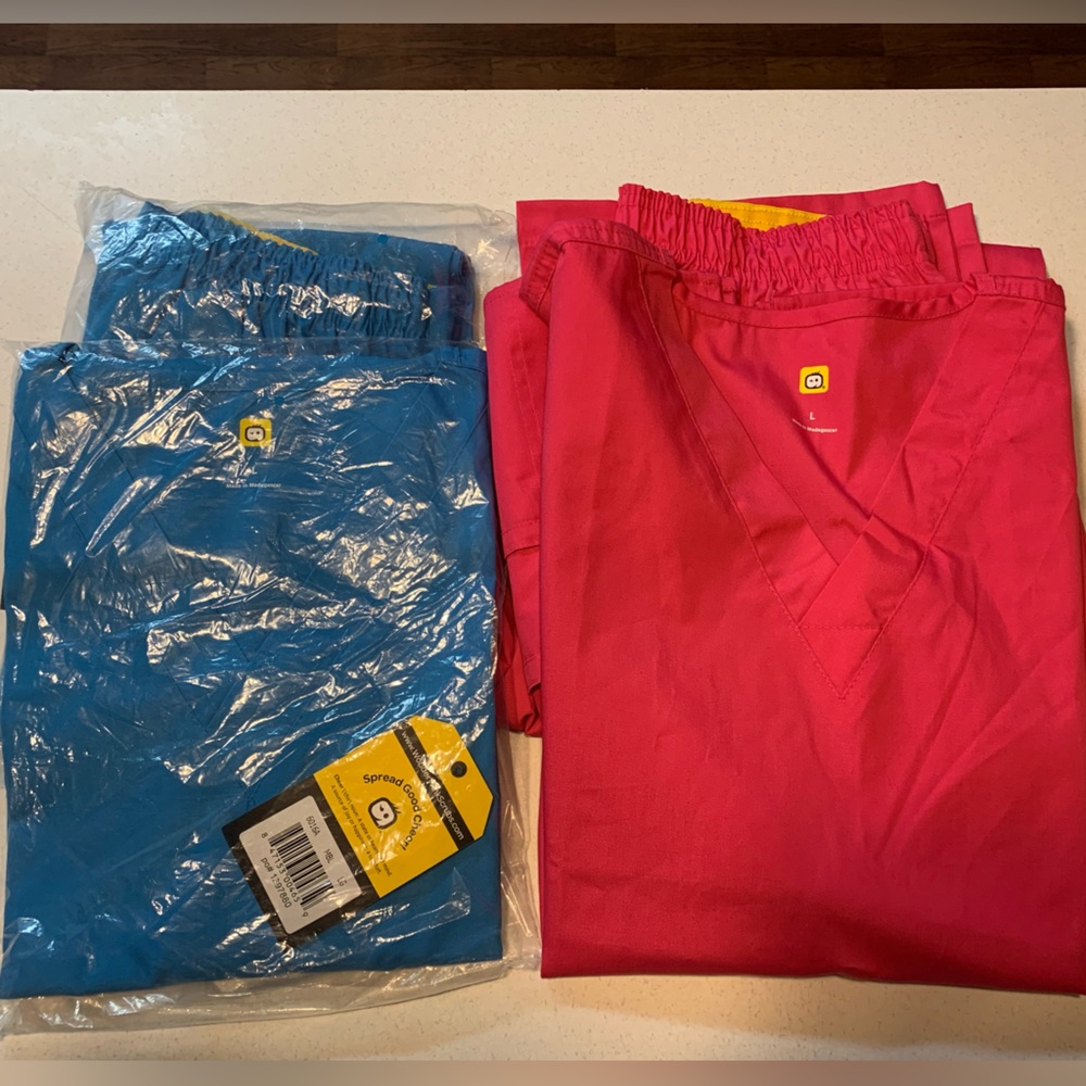 2 pair of NWT wonder wink scrubs size LARGE. Pink and blue
